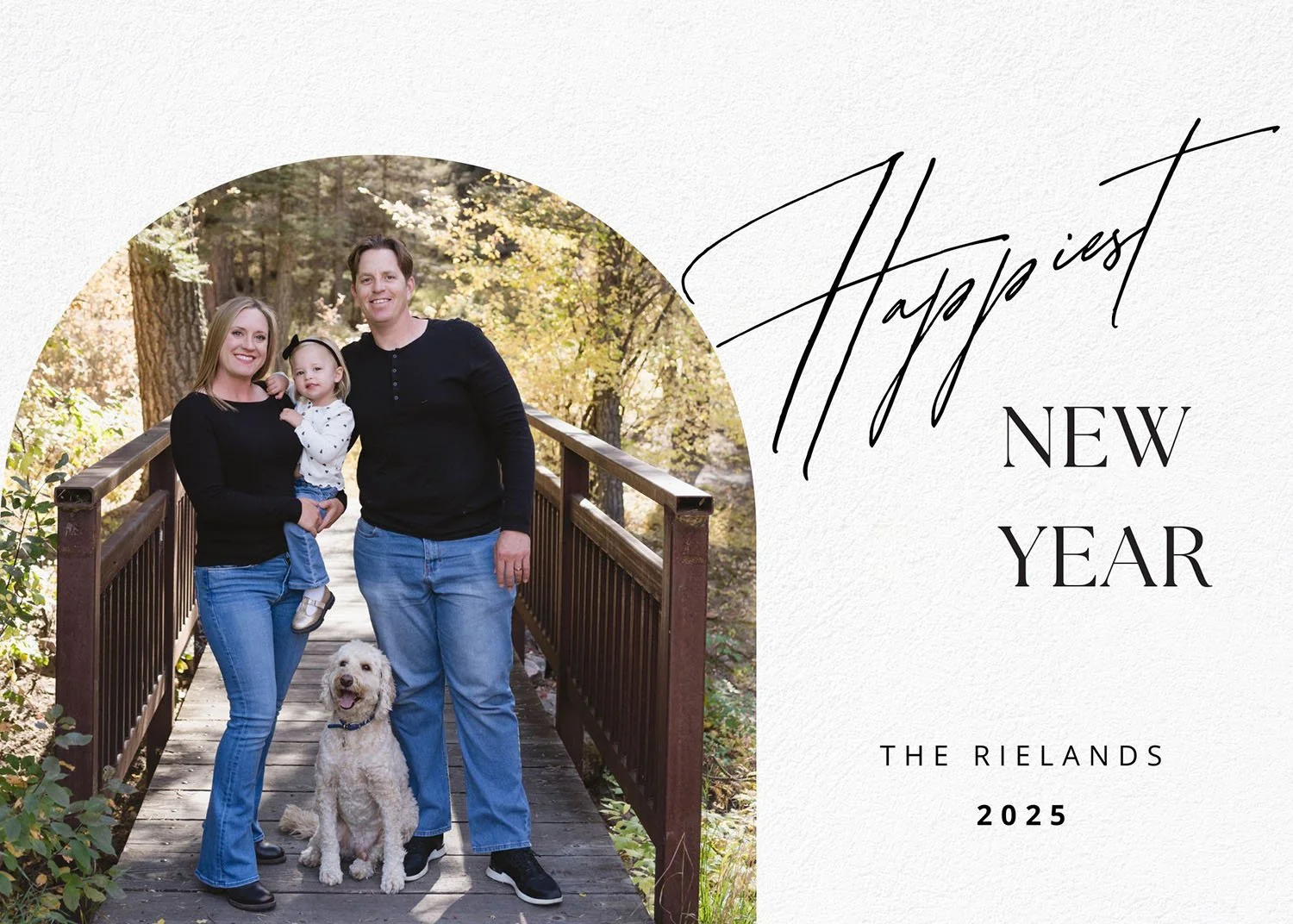 A family of three with a dog standing on a wooden bridge in a wooded area during autumn, with the words 'Happyist New Year 2025' and 'The Rielands' printed on a textured white background.