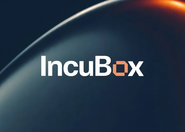 The logo of IncuBox with white and orange text on a dark background featuring a curved light streak.