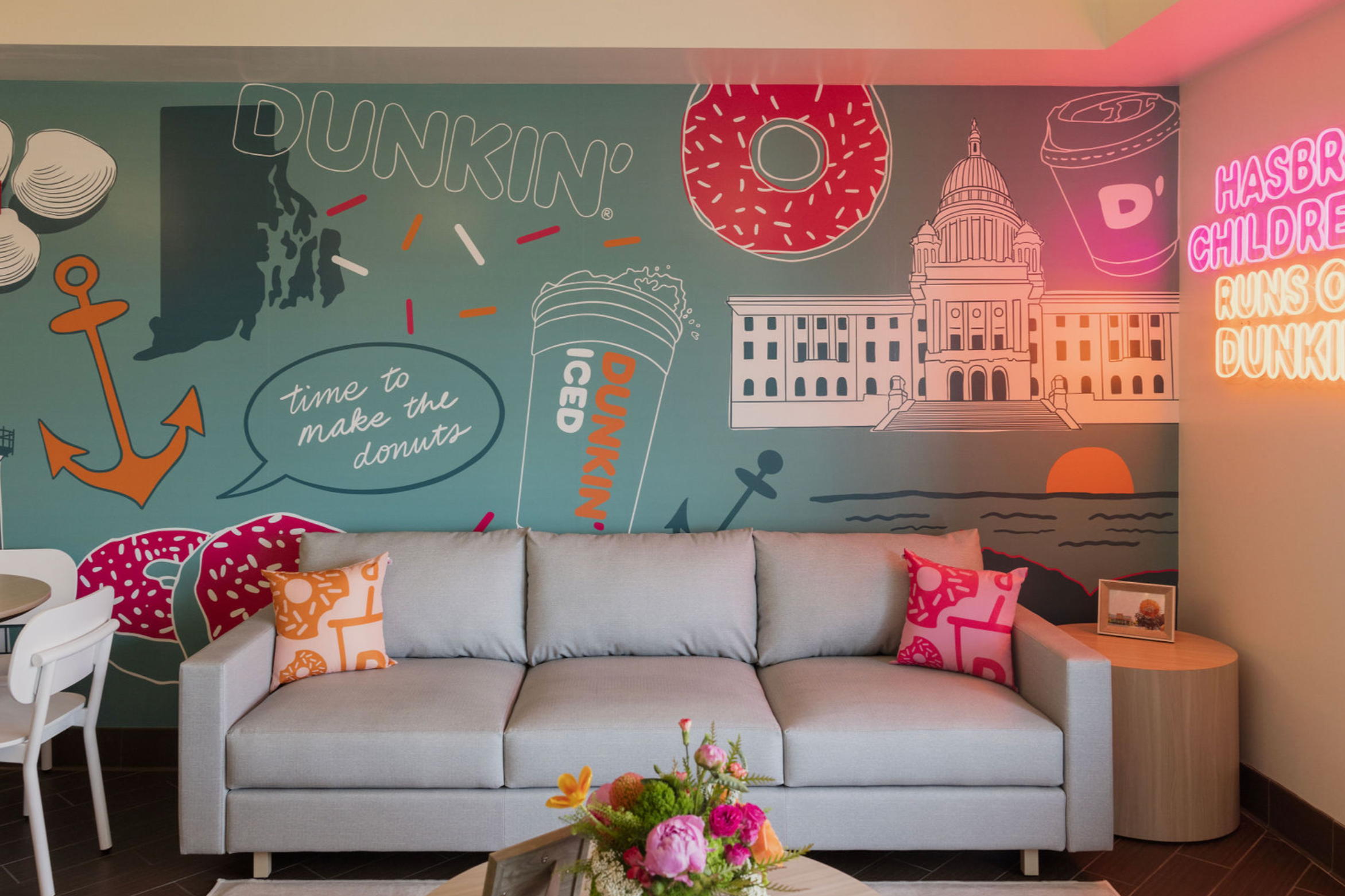 Dunkin' vinyl mural designed by San Diego mural artist Pandr Design Co. showing Rhode Island icons and nautical themes in pink, orange, and turquoise.