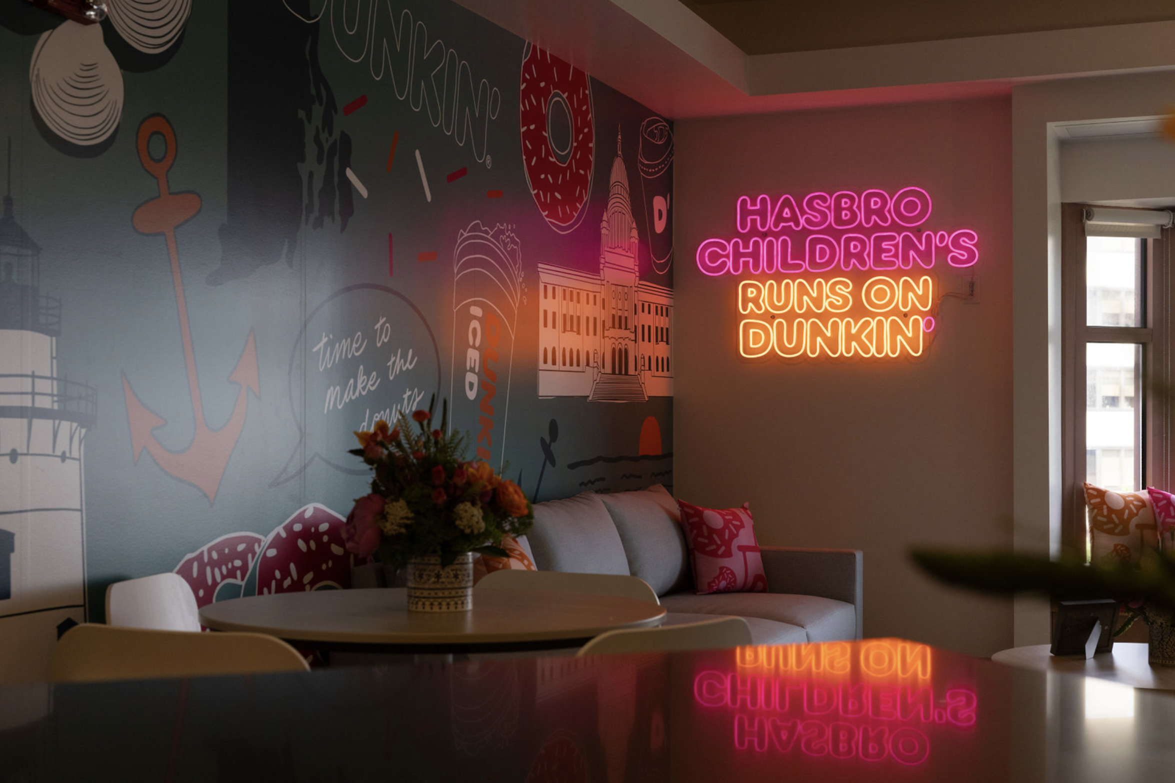 Dark room featured a Dunkin' mural designed by San Diego muralist Pandr Design Co., featuring nautical imagery in pink, orange and turquoise.