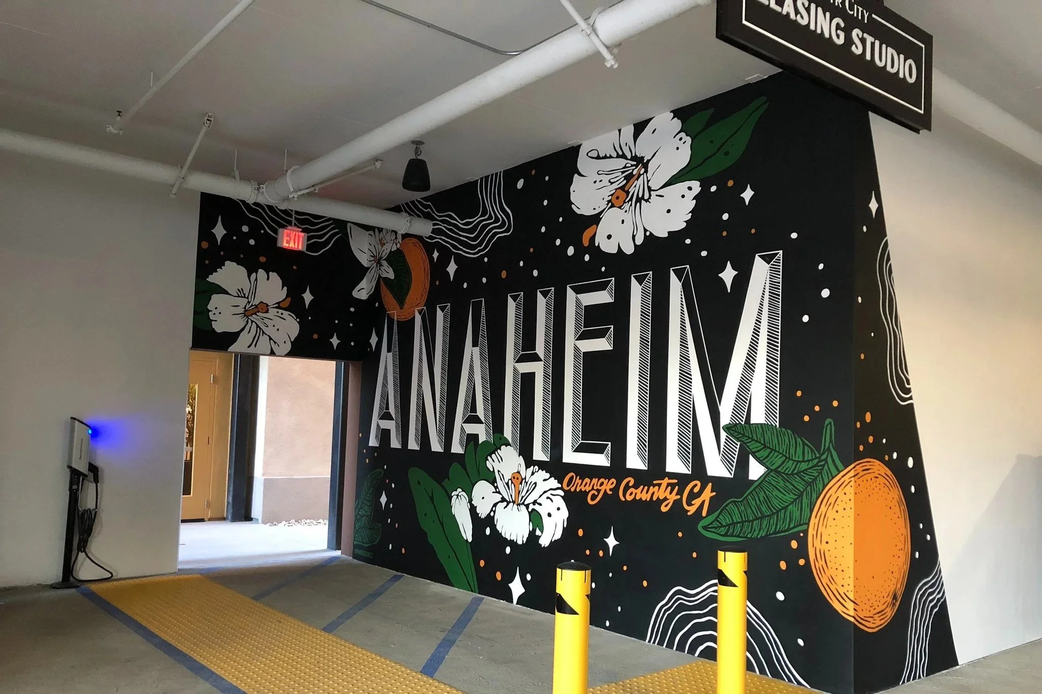 Black and white Anaheim parking garage mural featuring oranges by Pandr Design Co.