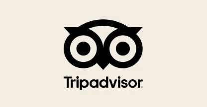 TripAdvisor logo with owl face in black and white