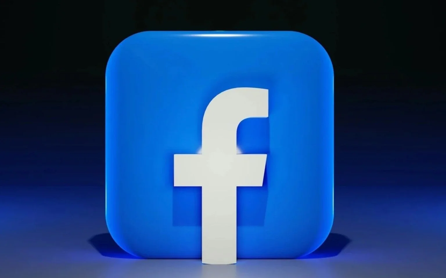 Facebook logo with a large white 'f' on a blue rounded square background, illuminated and shadowed on a dark surface.