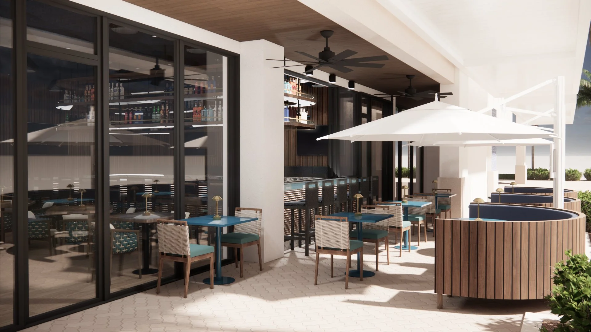 Outdoor patio of a modern restaurant or bar with tables, chairs, white umbrellas, and a bar area with a variety of bottles inside. Large glass windows separate the indoor and outdoor spaces in Deerfield Beach.