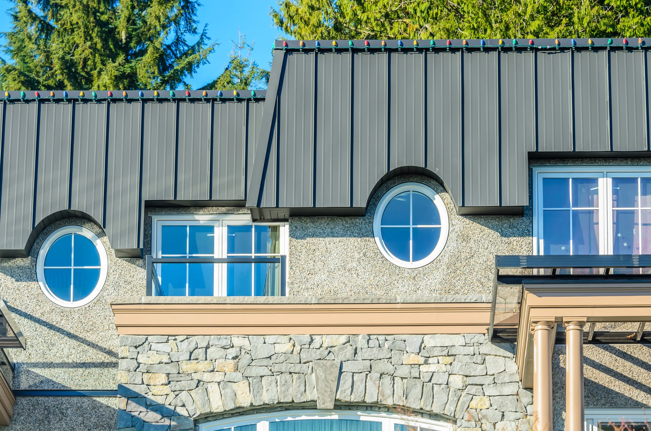 Standing seam metal roofing on nice house with Christmas lights