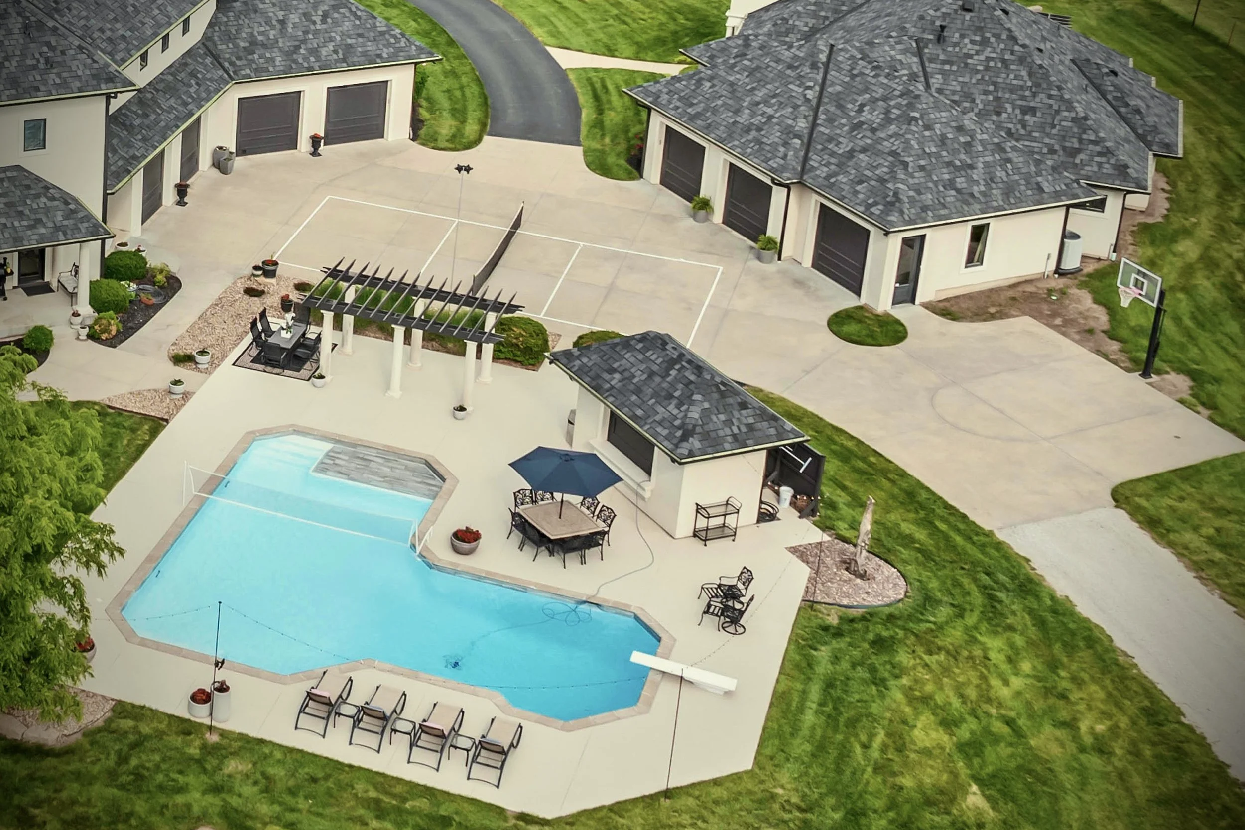 Photo of residential amenities like a swimming pool, pickle ball, and basketball court.