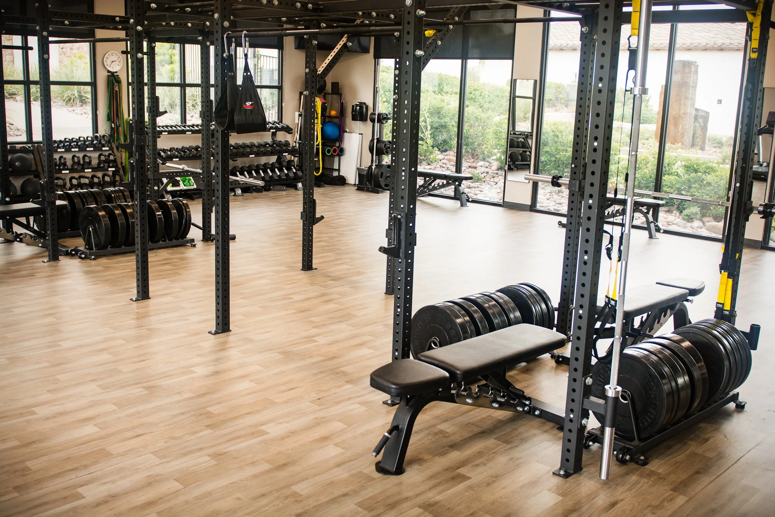 Lake Las Vegas Sport Club Performance gym with weight racks, dumbbells, kettlebells, medicine balls, resistance bands, and a bench, treadmill.