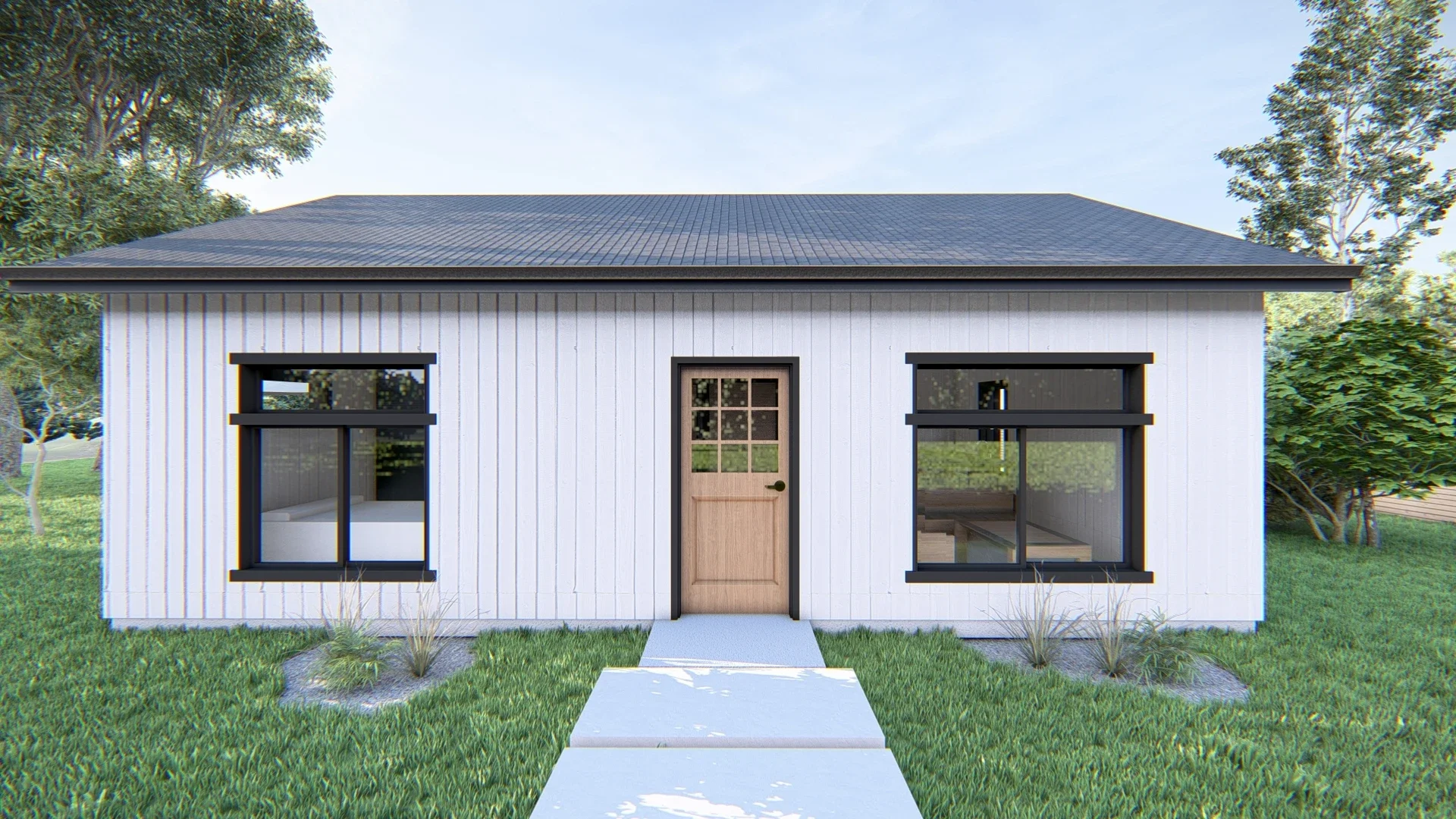 Front view of a modern small house with white vertical siding, black window trims, and a black roof. There is a wooden door with a small grid window in the center. A concrete walkway leads up to the door, surrounded by green grass and small plants. T