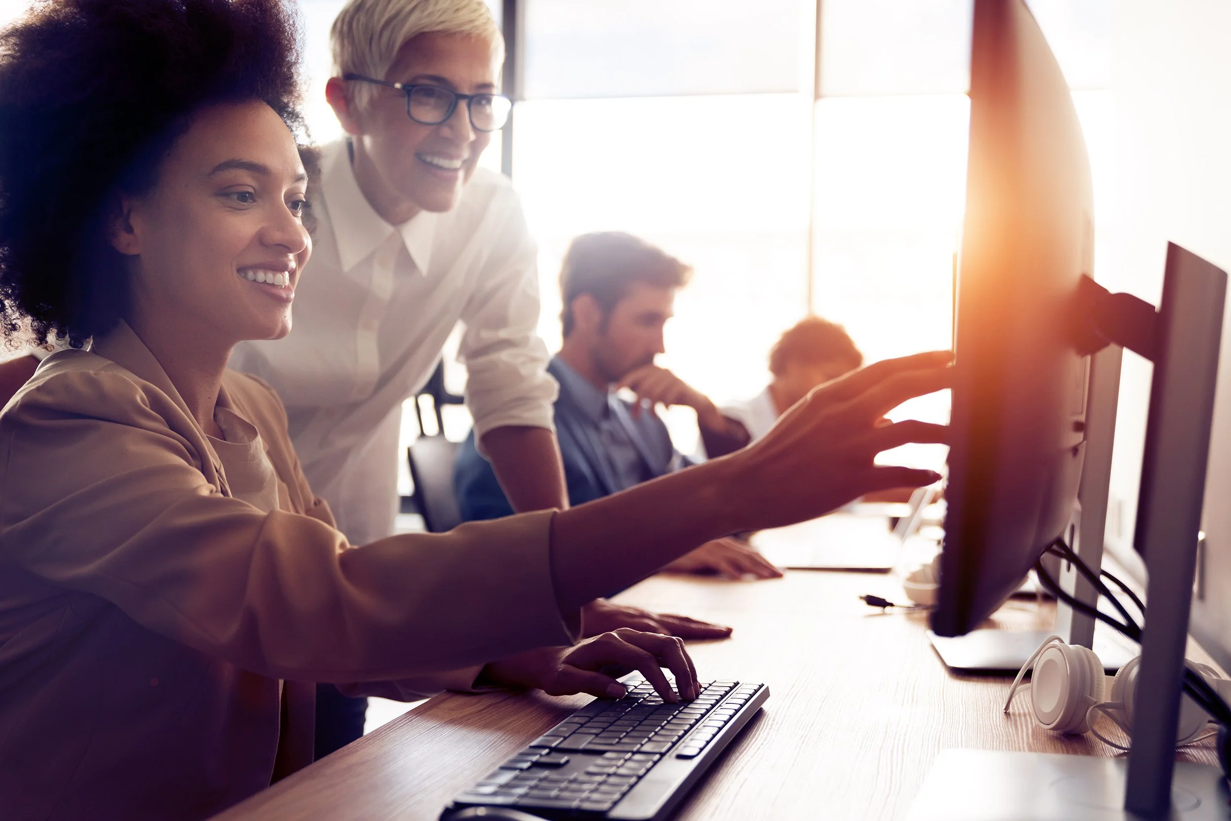 Software engineers looking at a computer monitor