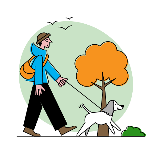 A person walking a dog on a leash in a park with green grass, a tree with orange leaves, and a bird flying in the sky.