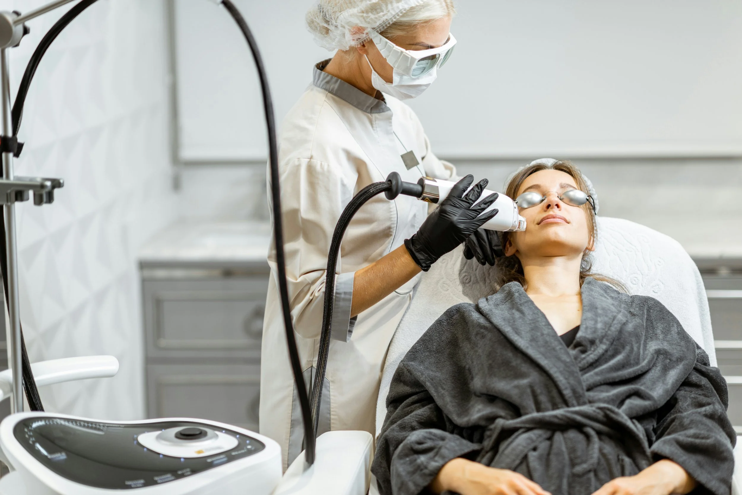A woman getting a Halo Hybrid Fractional Laser done to her face.