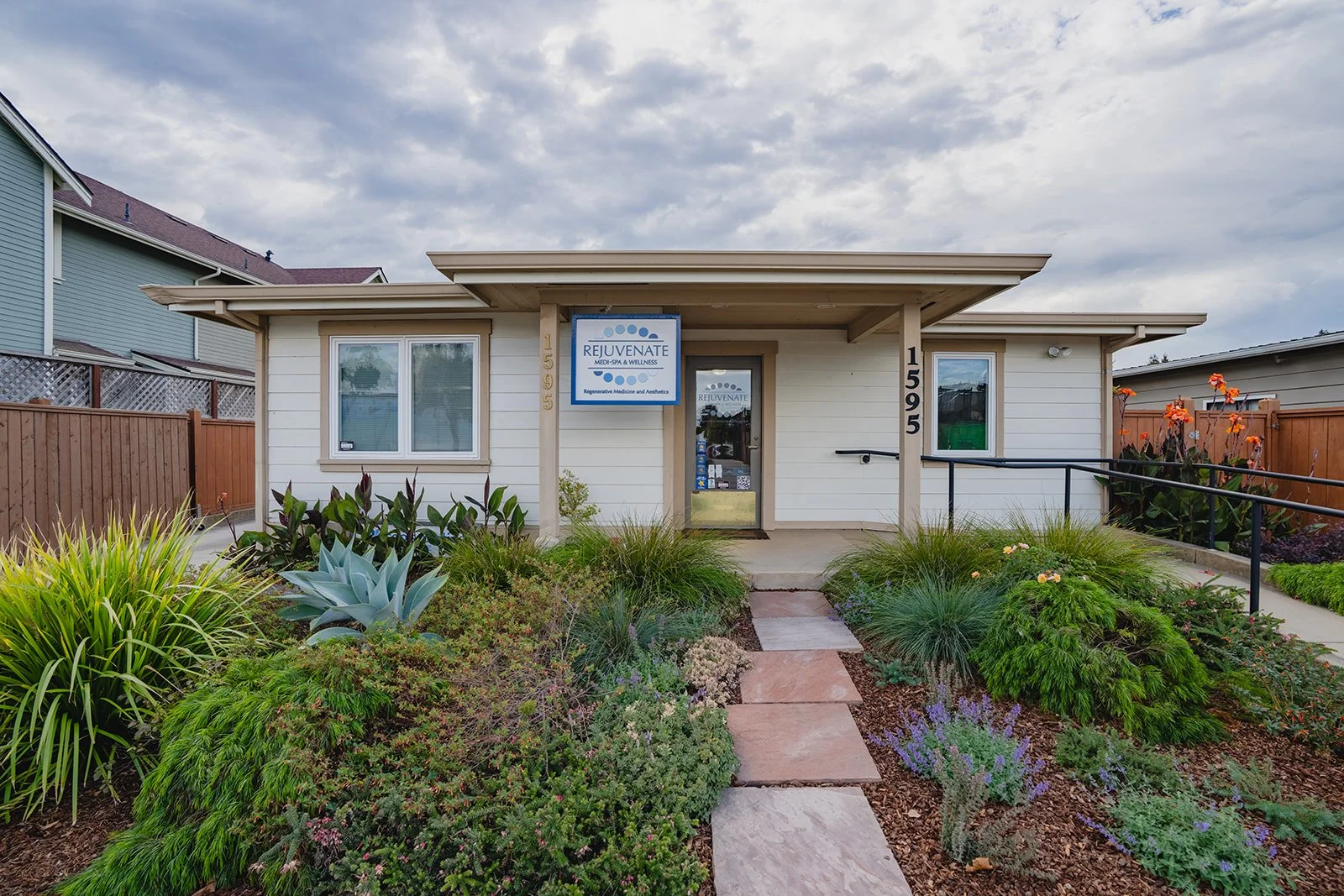 A photo of the store front of Rejuvenate. With the sign and plans in the front.