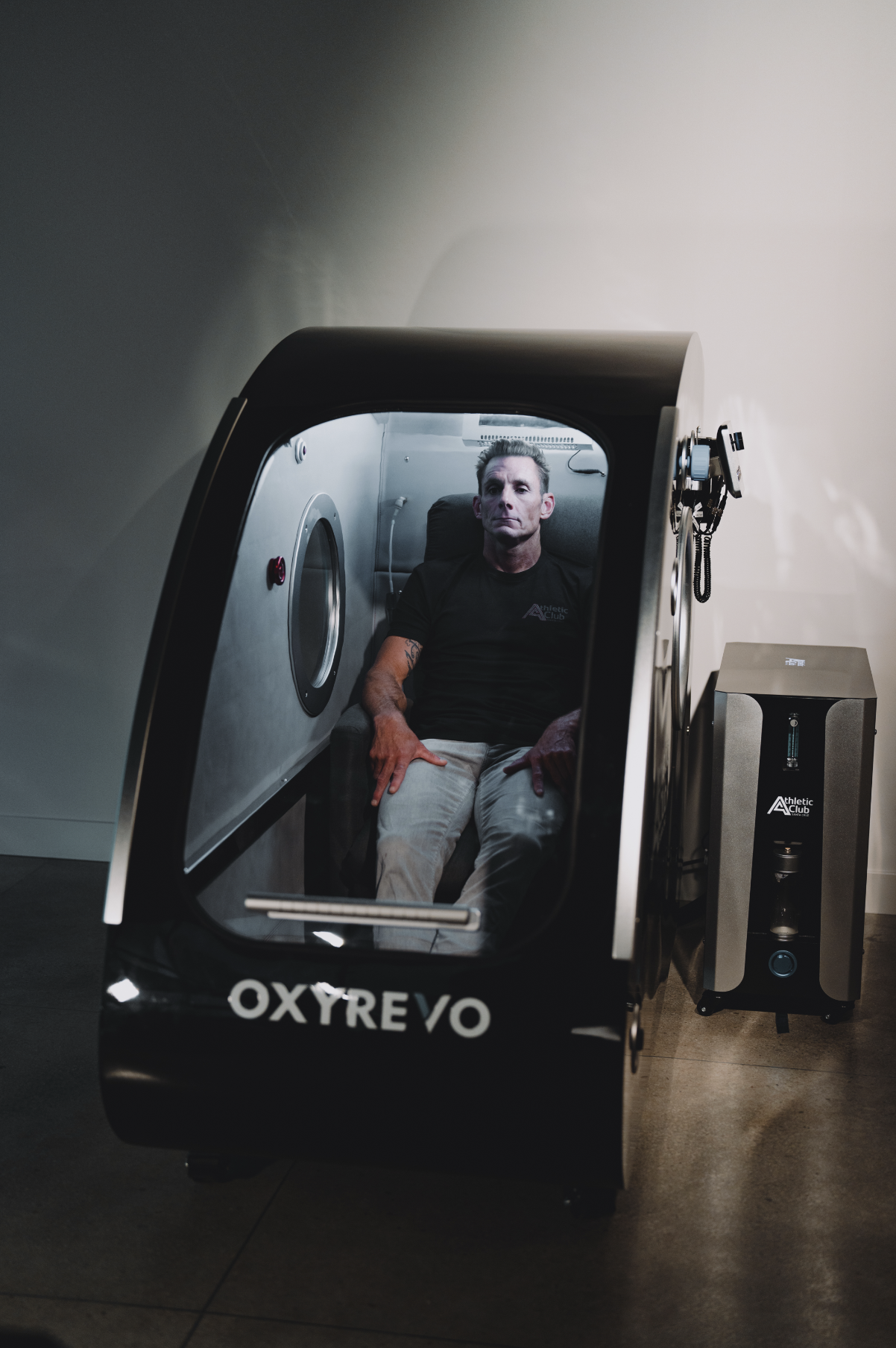 A man sitting in a hyperbaric oxygen therapy chamber.