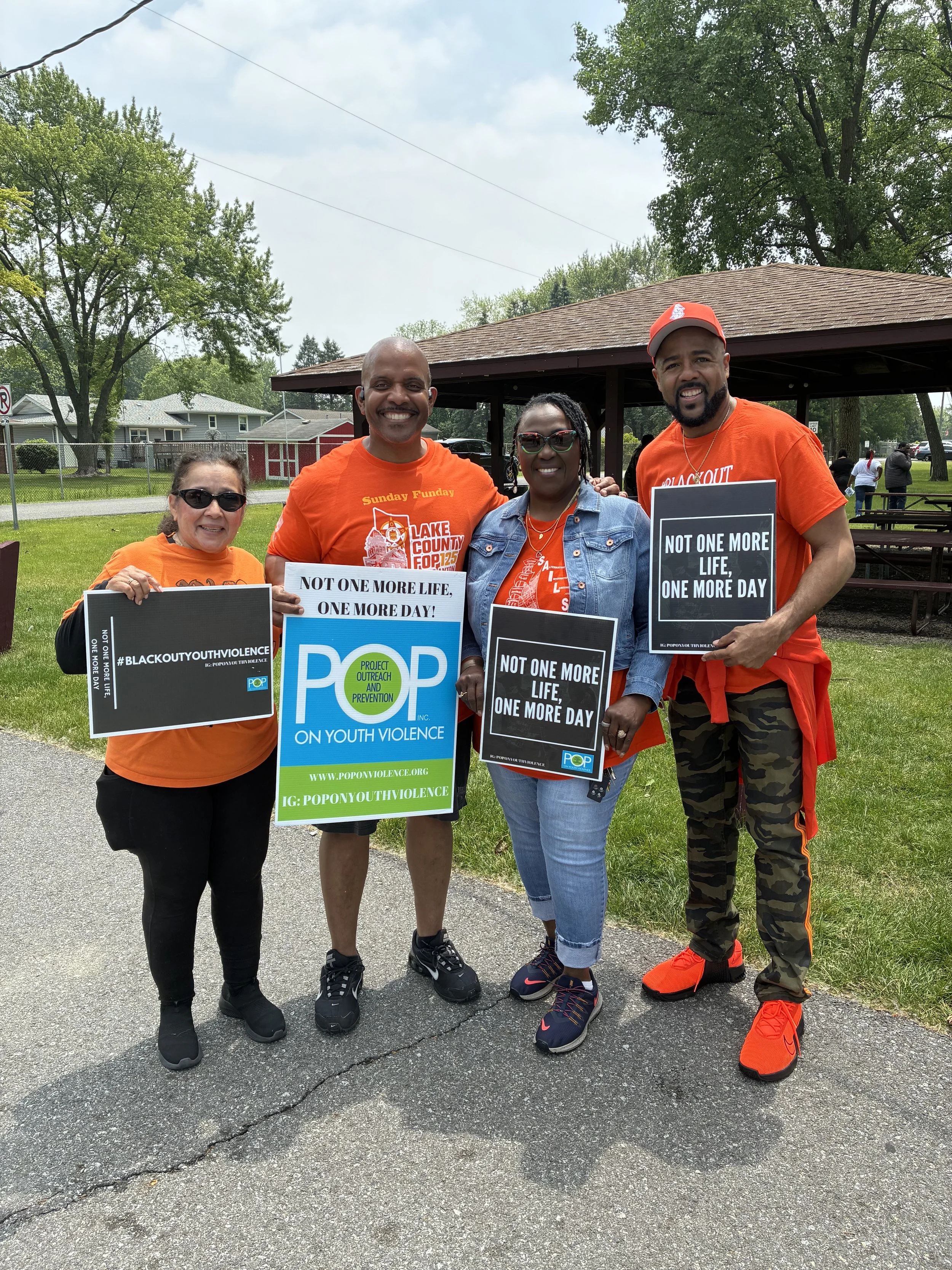 Supporters standing with Edward Jenkins for Lake County, Indiana Sheriff, the current deputy chief of police for Lake County, at an event holding signs advocating against youth violence.