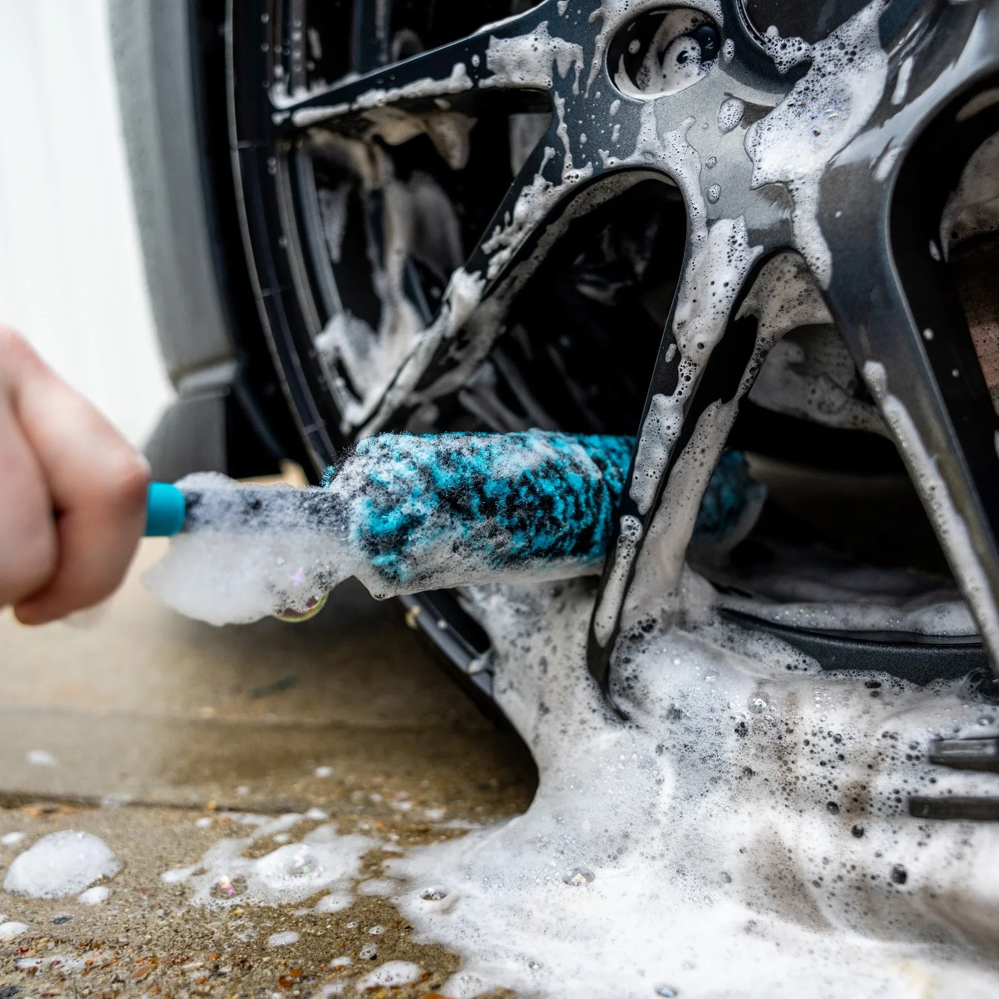 Wheel and tire cleaning with brushes during wash and wax service