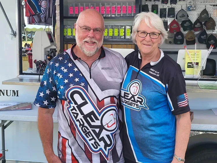 A smiling man and woman wearing Target-themed shirts posing together at a booth or stall.
