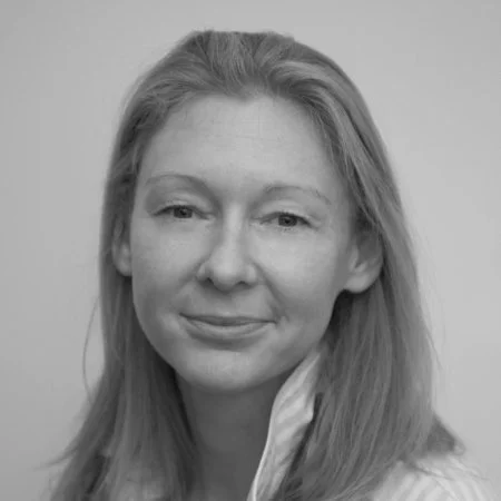 Black and white portrait of a woman with long hair, smiling slightly, facing forward.