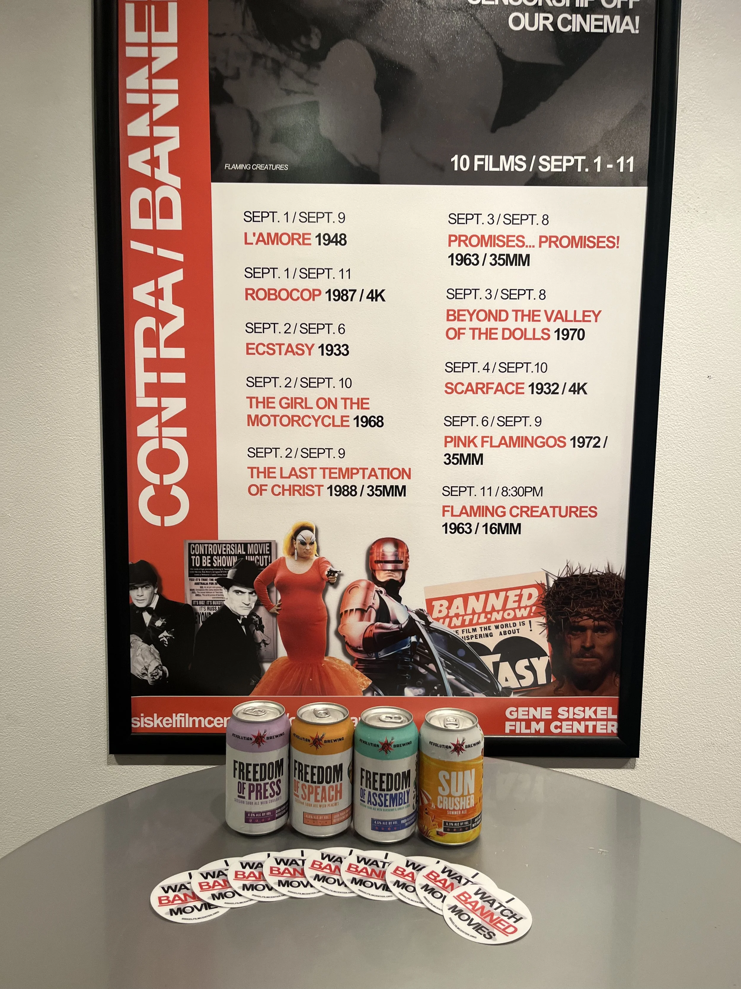 Lobby poster pictured with stickers and Revolution Brewery cross-promotion