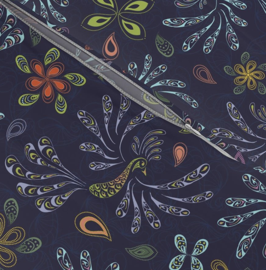 Colorful floral and bird pattern on fabric with a ruler placed across it.