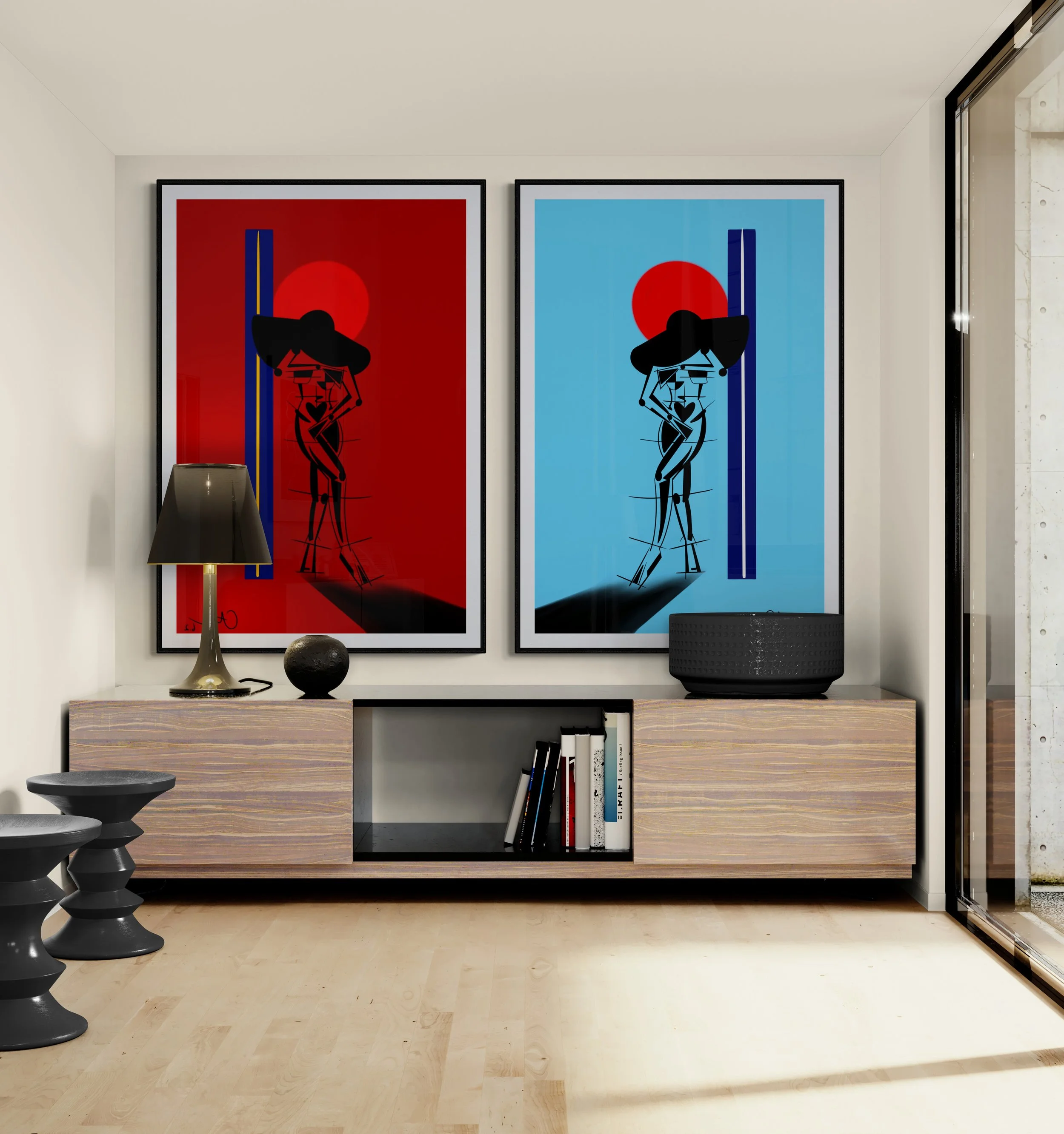 Living room with two large framed abstract art prints of women, one on a red background and one on a blue background, hanging above a wooden console table. The table has a black lamp, a black sphere, and a black basket. There are black stools beside the table and a glass door to the right letting in natural light.