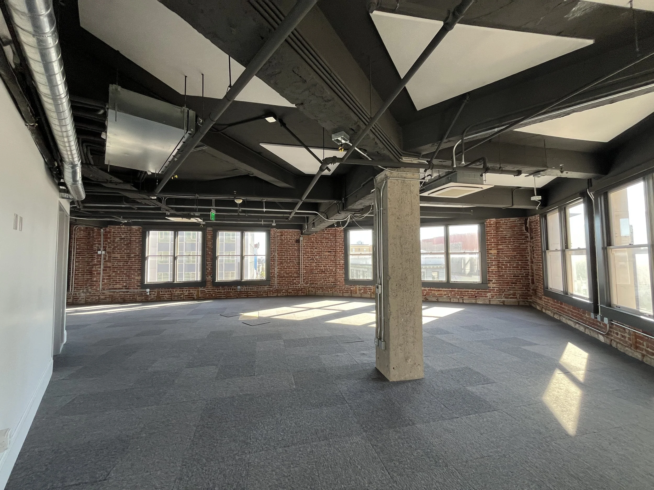  Warfield Commons 6th floor open space with brick walls. 