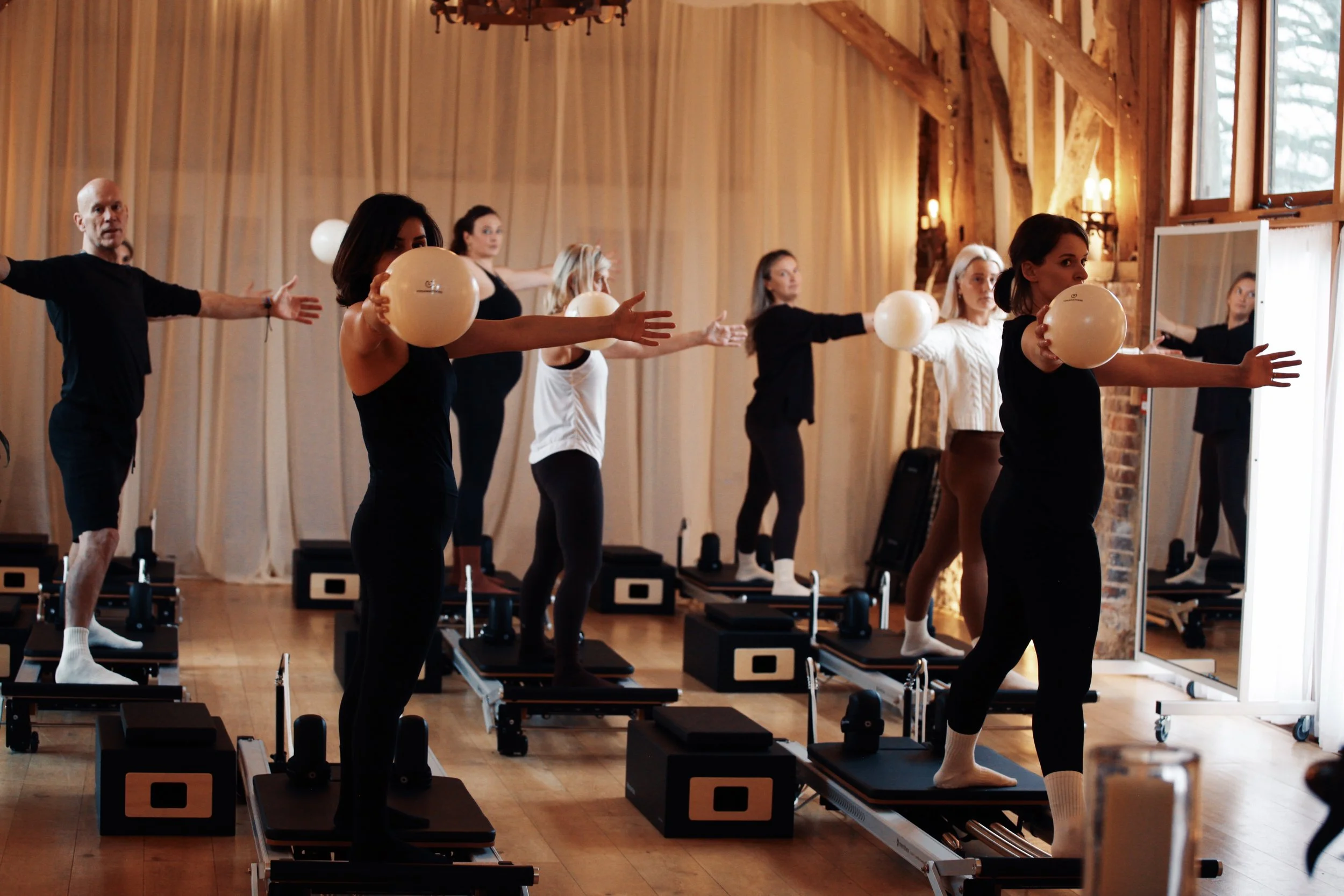 Students practising reformer Pilates techniques during professional Pilates teacher training at SoulSpace Academy.