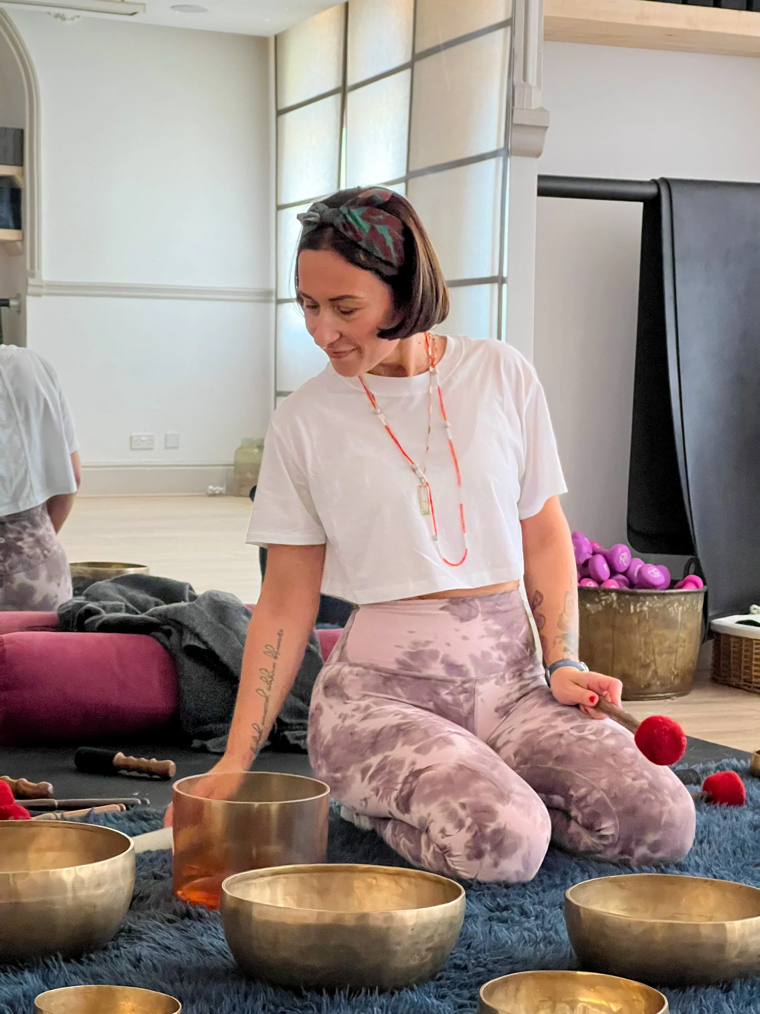 Yin yoga teacher trainer facilitating reflective learning and group discussion during professional Yin yoga teacher training.