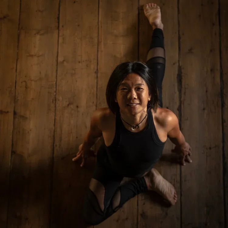 Specialist yoga educator demonstrating advanced movement practice during teacher training at SoulSpace Academy.