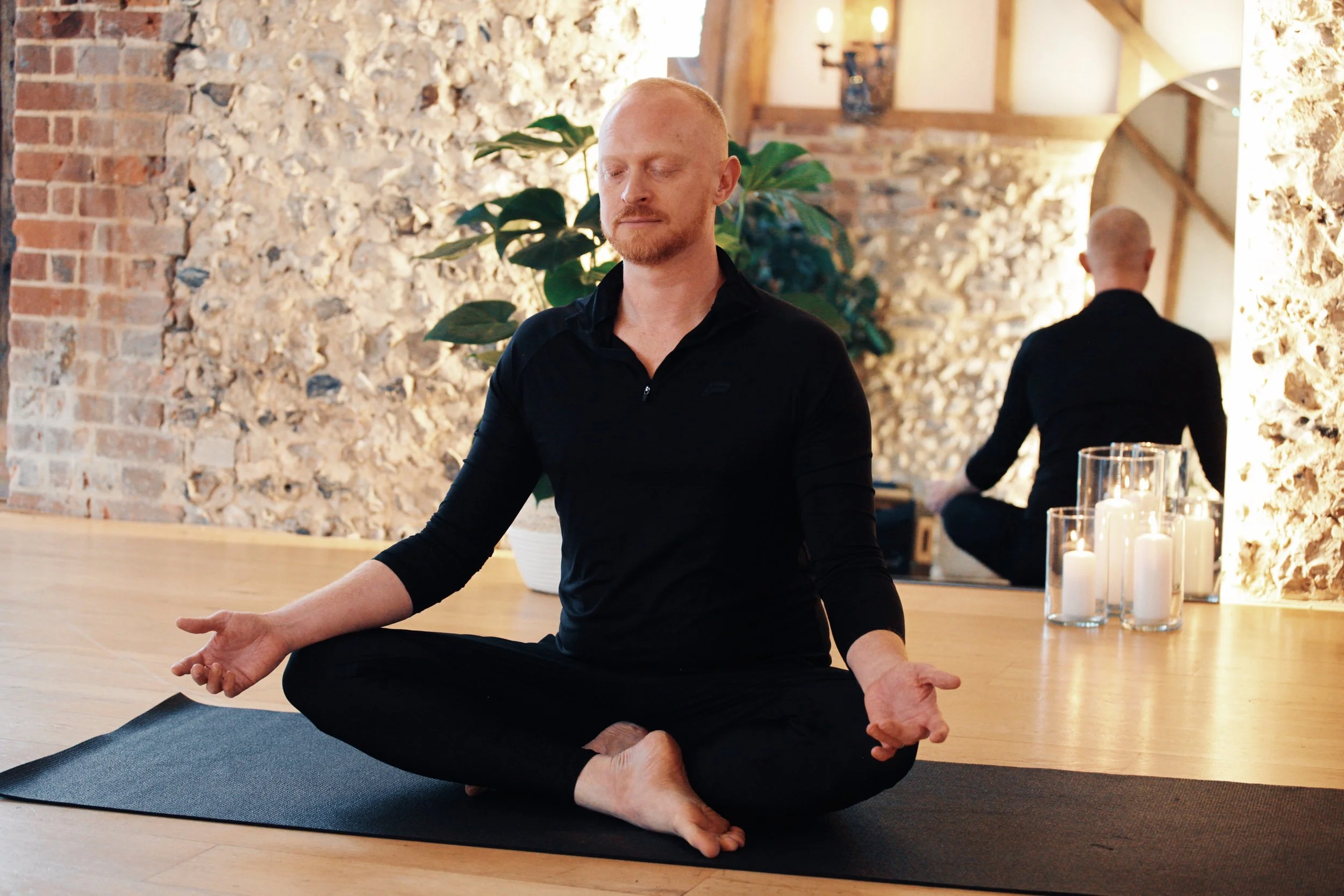 Yoga teacher trainee practising mindfulness and meditation as part of holistic teacher training.