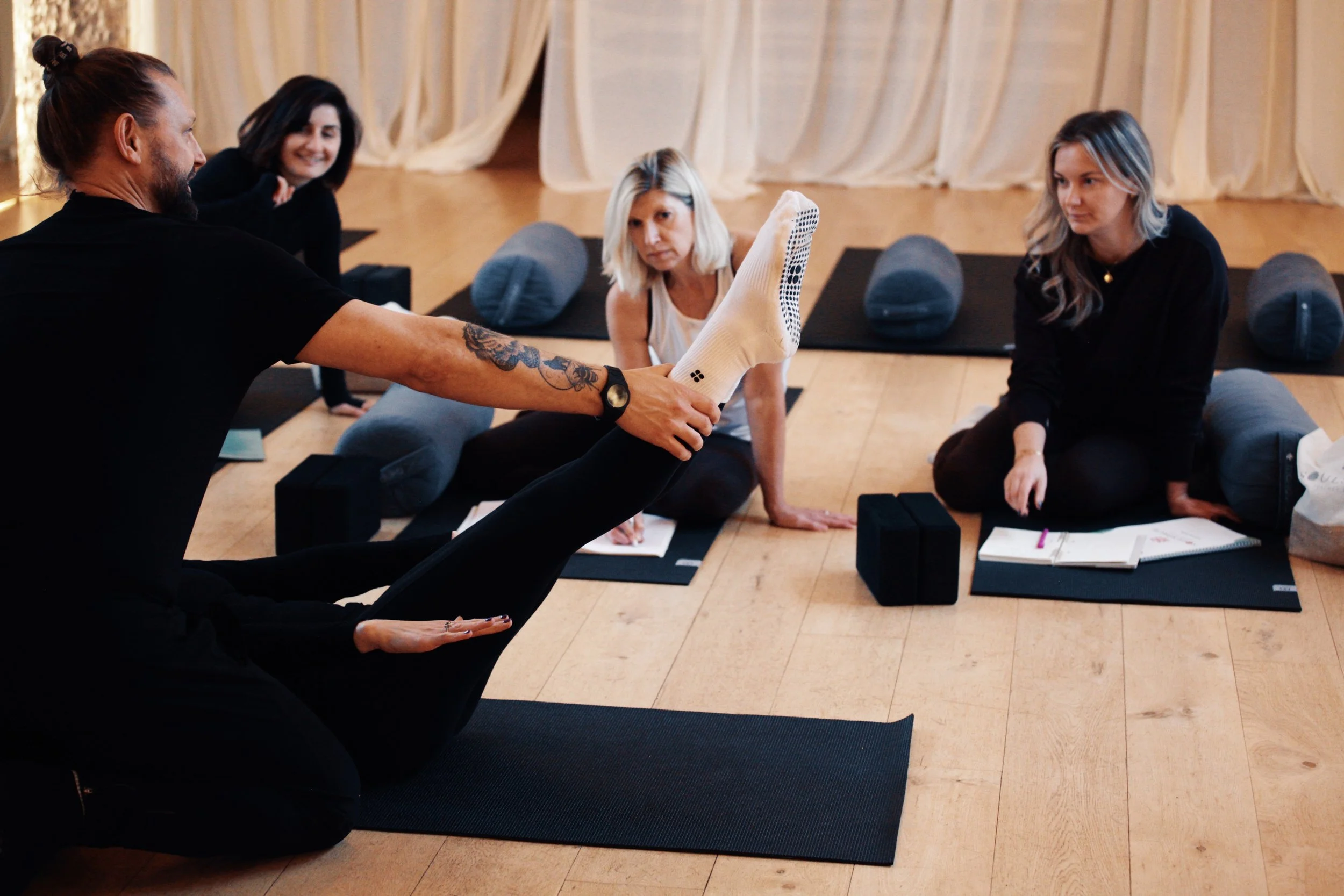 Students observing movement assessment and exercise technique demonstration during Pilates teacher training at SoulSpace Academy.