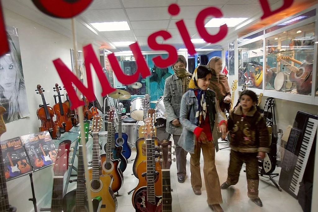 An Afghan man changes cassettes in a music shop in Herat, 2001. Music was strictly forbidden under the Taliban regime. (AFP PHOTO/Behrouz MEHRI via Getty Images)