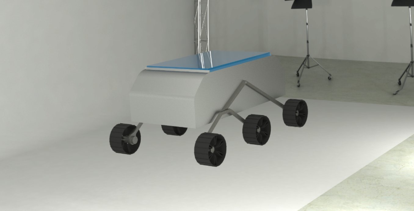 A robot with four black wheels and a metallic body, positioned in a studio with lighting equipment in the background.