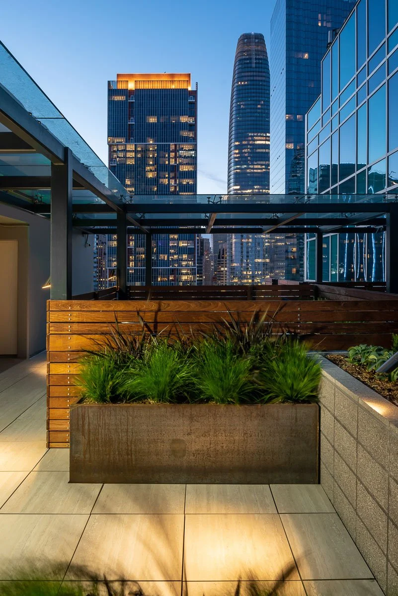metal planter at night with Salesforce tower in background