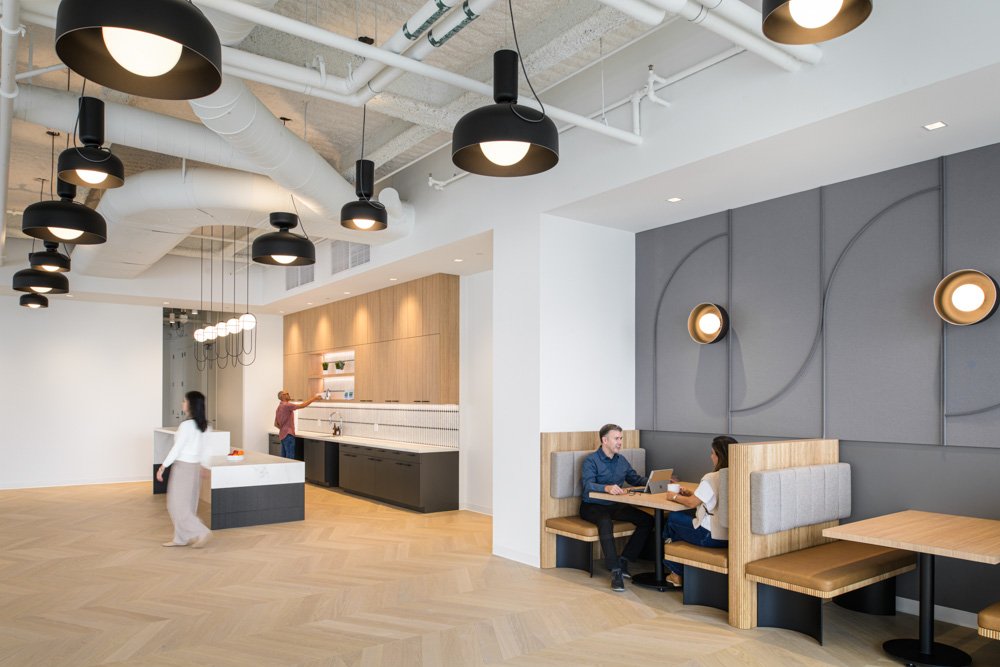 modern kitchen and banquette seating in an office with neutral tones
