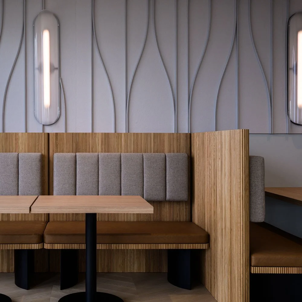 detal view of ribbed wood banquette seating with gray cushions and gray acoustical wall