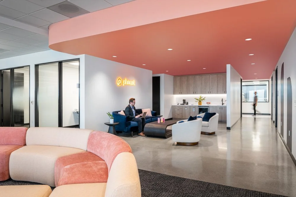 office lounge with salmon colored accent ceiling