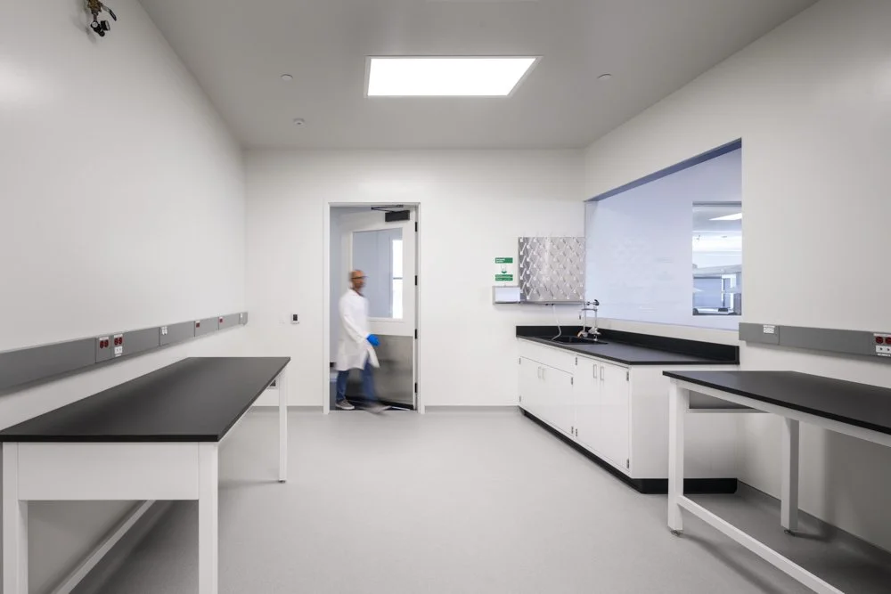 lab work room, worker entering, work benches and sink