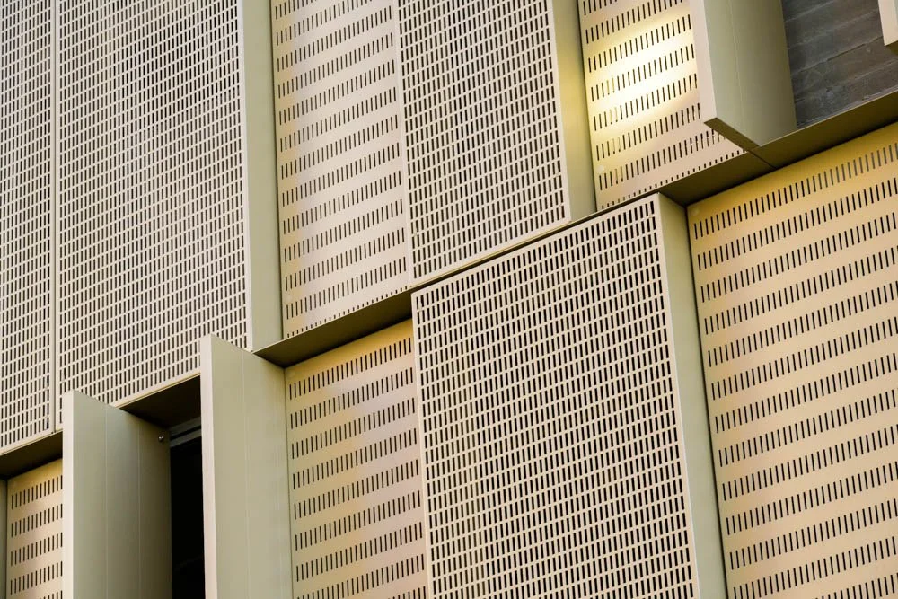 detail of bronze colored perforated panels