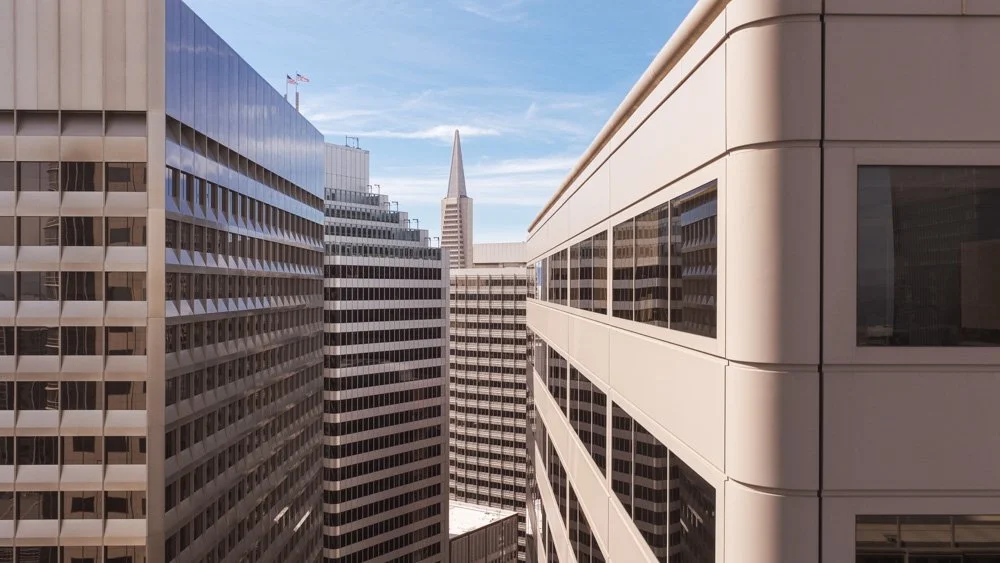 layers of highrise office buildings with Transamerica Pyramid in background
