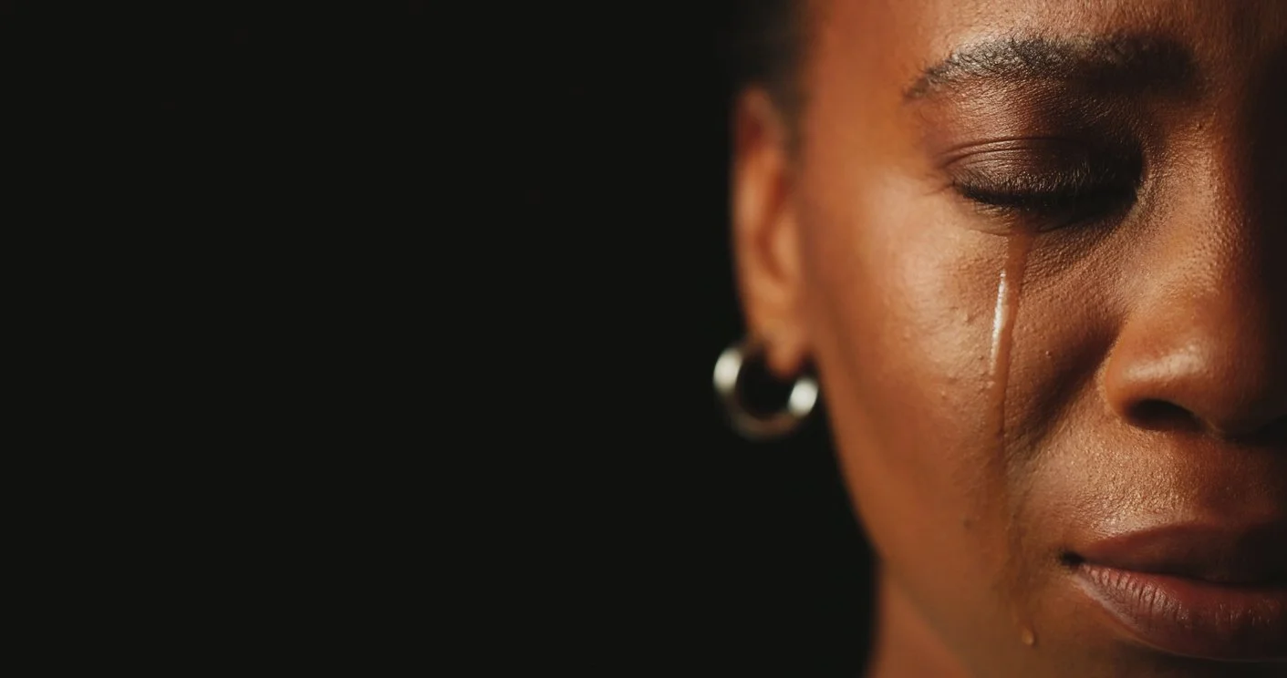 Abstract digital artwork of a human silhouette with a luminous, transparent body standing against a cosmic, colorful background with swirling galaxies and bright starbursts.