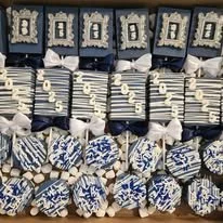 Stack of cushions with blue and white patterns, arranged on a shelf.