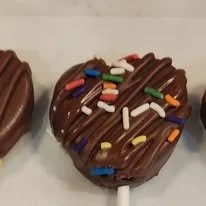 Chocolate-covered lollipops with colorful sprinkles