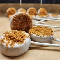 Peanut butter and jelly snowballs and marshmallows coated with crushed graham crackers.