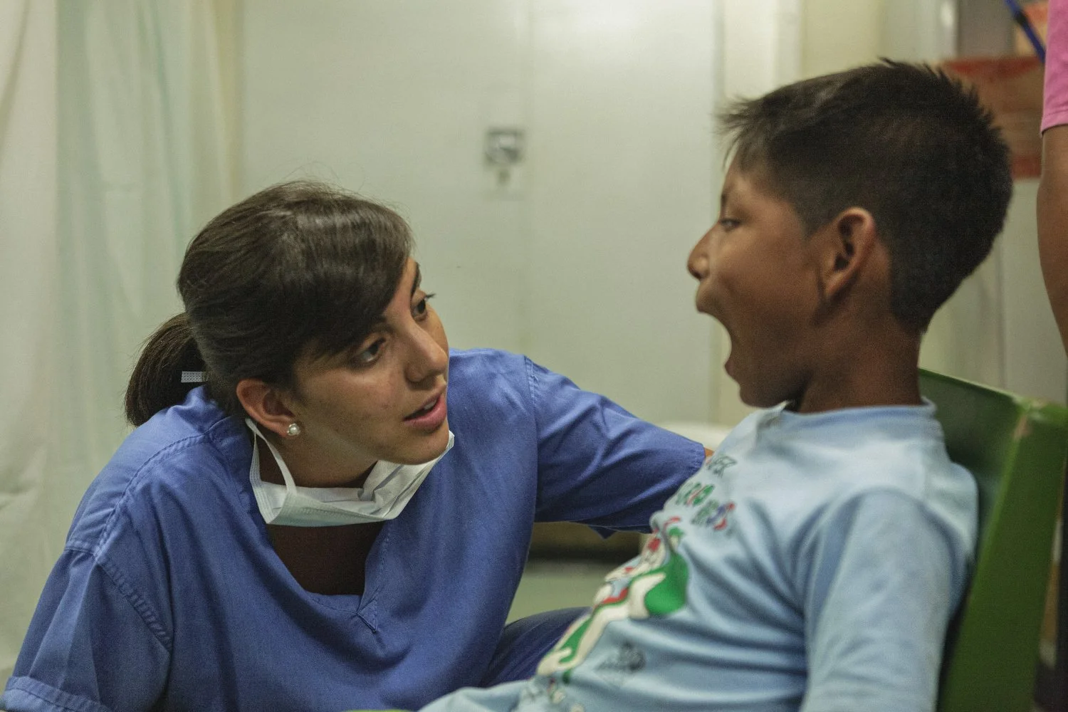 A young boy opens his mouth during a dental checkup aboard the Amazon Hope mission boat.