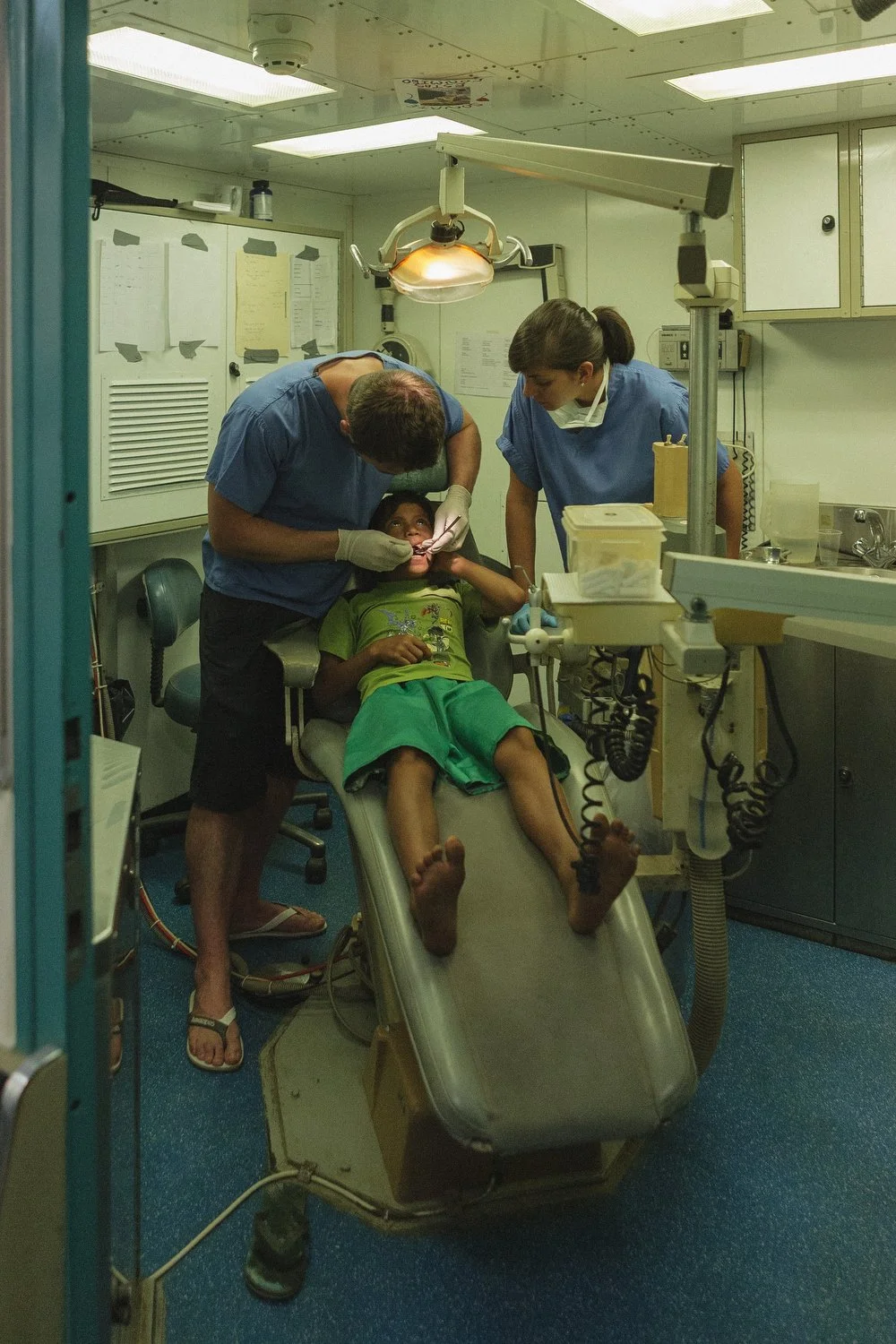 Volunteer dentists care for a child in the onboard dental clinic of the Amazon Hope mission boat.