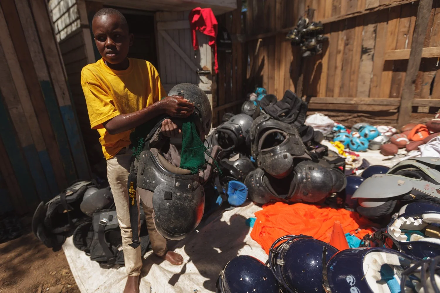 A Kenyan boy prepares to use donated football helmets and shoulder pads provided by Fellowship of Christian Athletes during a mission trip in Nakuru, Kenya, January 2012.