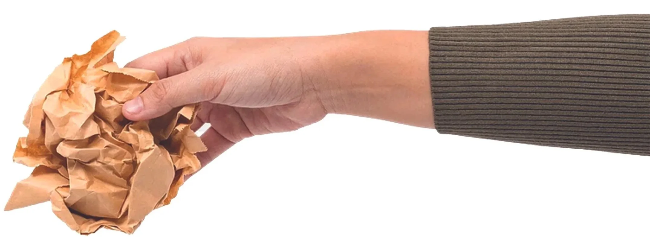 A hand holding a crumpled piece of brown paper