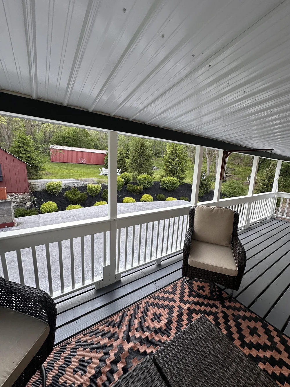 Covered back deck view looking out toward the backyard and landscaped grounds