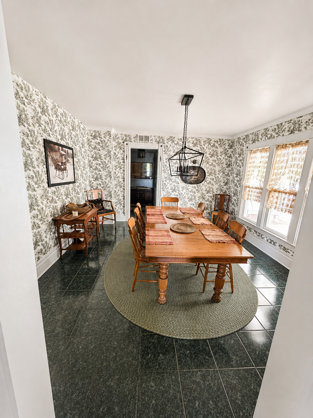 Unit 1 main dining room with large dining table and classic main house details
