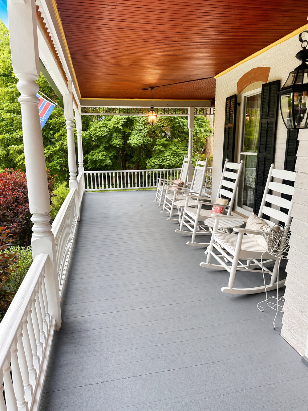 Front deck view showing covered porch seating and rocking chairs
